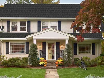 Two-story, mid-class home with black GAF shingles on its roof