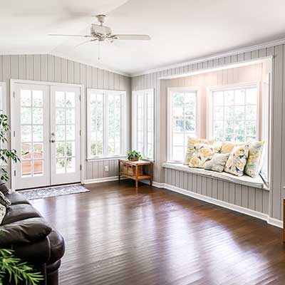 Modern home living room space with large windows letting in sunlight