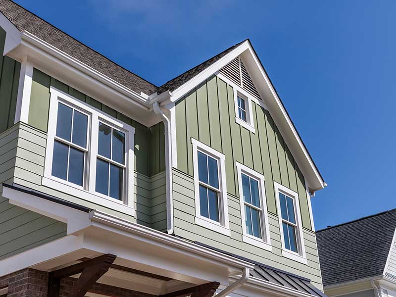 Two-story, mid-class home with green siding