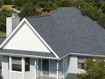 Two-story, mid-class home with gray CertainTeed shingles on its roof
